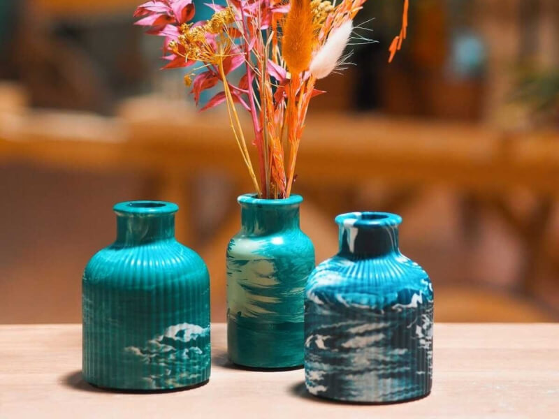 A selection of three aqua and white marbled mini vases 